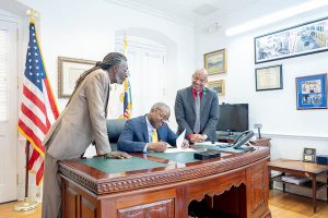 Senator Postive Nelson and Governor Albert Bryan sign medical marijuana bill.